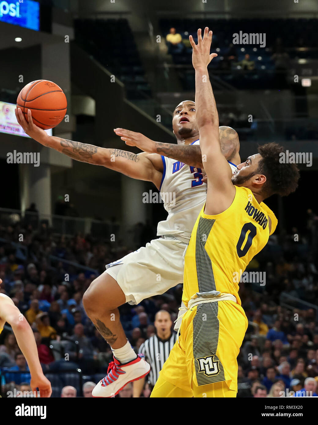Chicago, USA. 12th Feb 2019. DePaul Blue Demons guard Devin Gage (3) puts up an acrobatic layup while being defended by Marquette Golden Eagles guard Markus Howard (0) during NCAA basketball game between the Marquette Golden Eagles and the DePaul University Blue Demons at Wintrust Arena in Chicago IL. Gary E. Duncan Sr/CSM Credit: Cal Sport Media/Alamy Live News Stock Photo