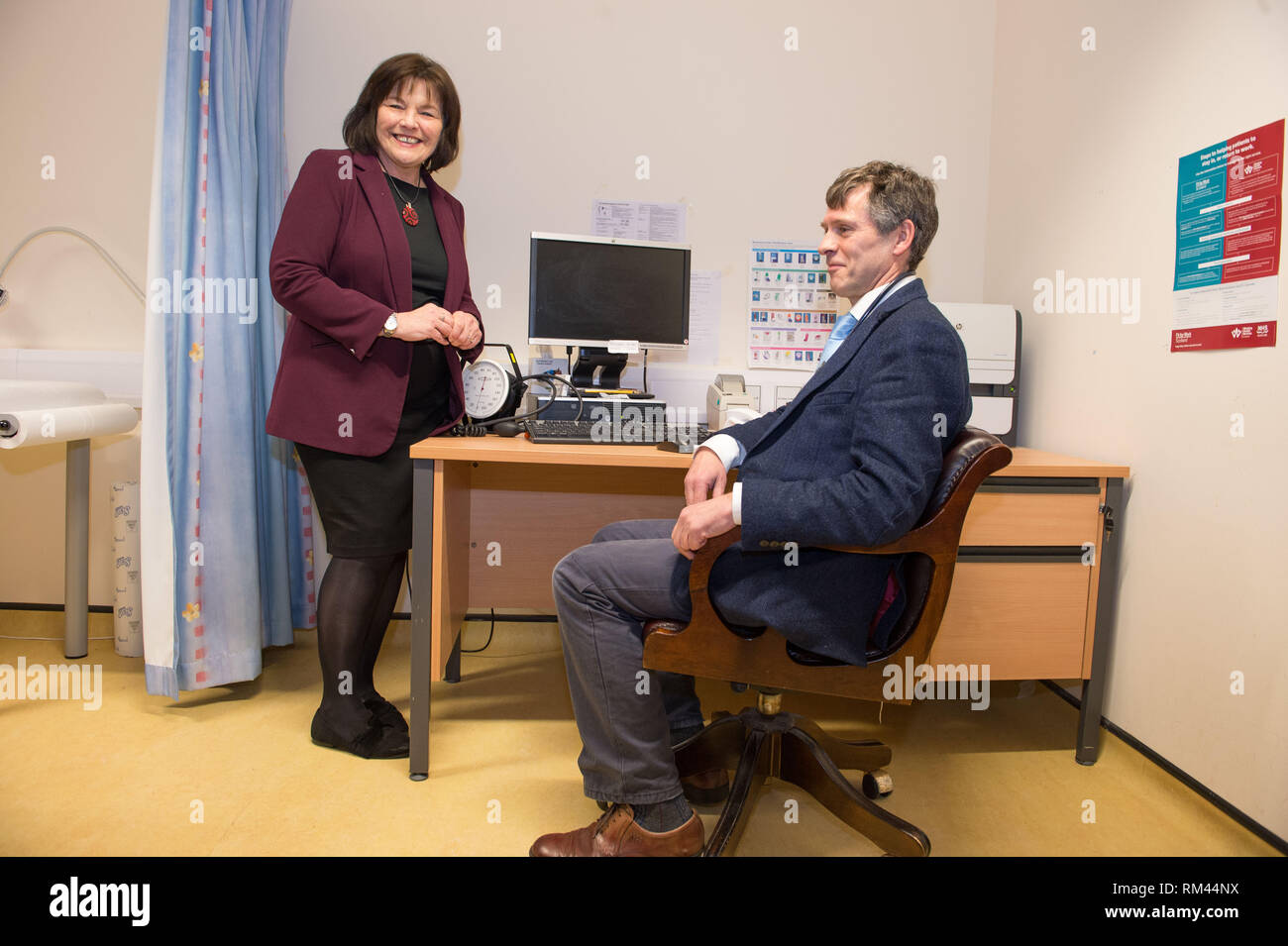 Glasgow, UK. 13th Feb, 2019. (L-R) Jean Freeman, Cabinet Secretary for Health and Sport; Alastair Douglas GP in Allander Surgery. who are pictured seen visiting a GP Practice - The Allander Surgery in Posil, Glasgow. The Health Secretary will announce funding for a scheme to give GPs extra support with the cost of running their own practices.  Credit: Colin Fisher/Alamy Live News Credit: Colin Fisher/Alamy Live News Stock Photo