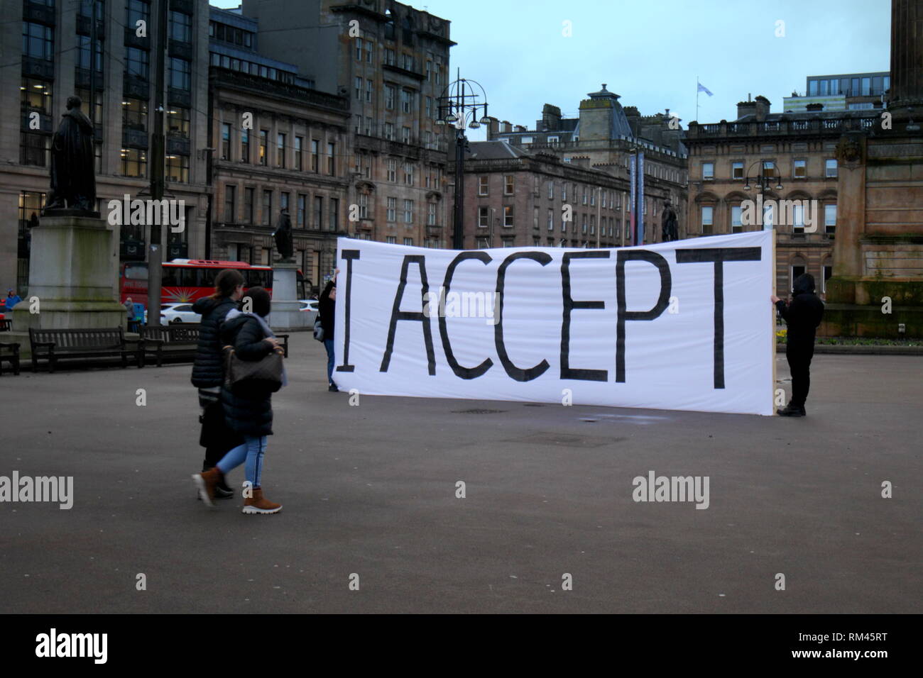 Glasgow, Scotland, UK 13th, February, 2019 On the day before valentines day a large white and black I accept banner was unfurled on the city’s George Square in front of the web cam  as passers by asked if it was a proposal confirmation it was stated as an gsa art student art project though we wait and see.  Gerard Ferry/Alamy Live News Stock Photo