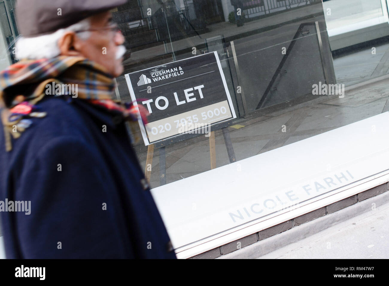 February 9, 2019 - London, United Kingdom - A man seen walking past a vacant store, previously a branch of designer clothing retailer Nicole Farhi, on Conduit Street in central London..February 15 sees the release of the first monthly retail sales figures of the year (for January) from the UK's Office for National Statistics. December figures revealed a 0.9 percent fall in sales from the month before, which saw a 1.4 percent rise widely attributed to the impact of 'Black Friday' deals encouraging earlier Christmas shopping. More generally, with a potential no-deal departure from the EU growing Stock Photo