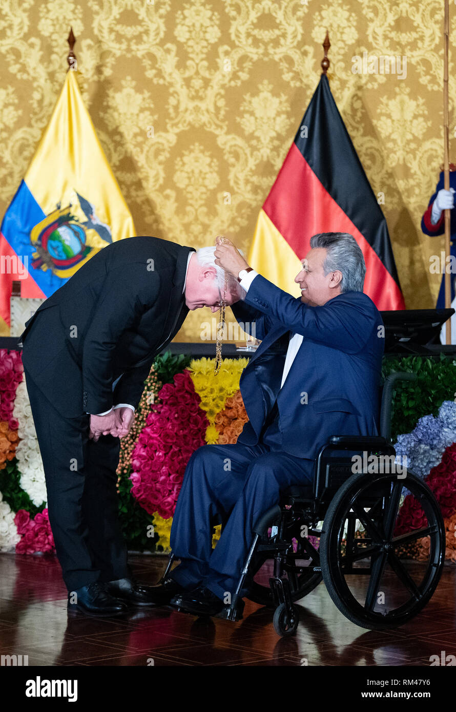 13 February 2019, Ecuador, Quito: President Frank-Walter Steinmeier (l) is awarded a medal by Lenin Voltaire Moreno Garces, President of Ecuador, in the Palacio de Carondelet, the presidential palace. Federal President Steinmeier and his wife are visiting Colombia and Ecuador on the occasion of Alexander von Humboldt's 250th birthday as part of a five-day trip to Latin America. Photo: Bernd von Jutrczenka/dpa Stock Photo