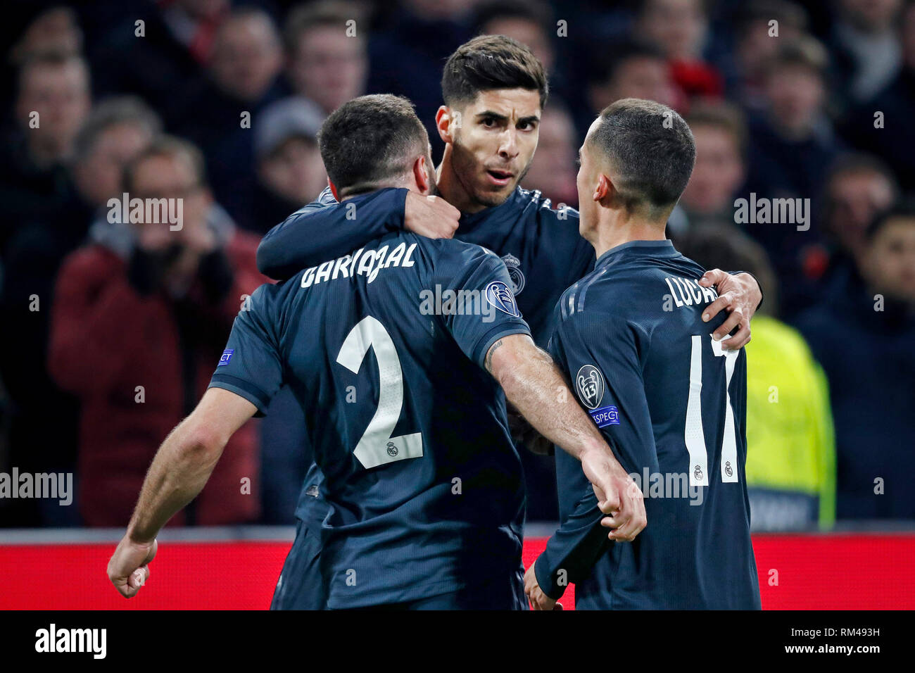 Amsterdam, Netherlands. 13th Feb, 2019. AMSTERDAM, Ajax - Real Madrid, football, Champions League Season 2018/2019, 13-02-2019, Johan Cruijff Arena. Real Madrid player Marco Asensio (C) celebrating his 1-2 with Real Madrid player Dani Carvajal (L) and Real Madrid player Lucas Vazquez (R) during the game Ajax - Real Madrid (1-2). Credit: Pro Shots/Alamy Live News Stock Photo