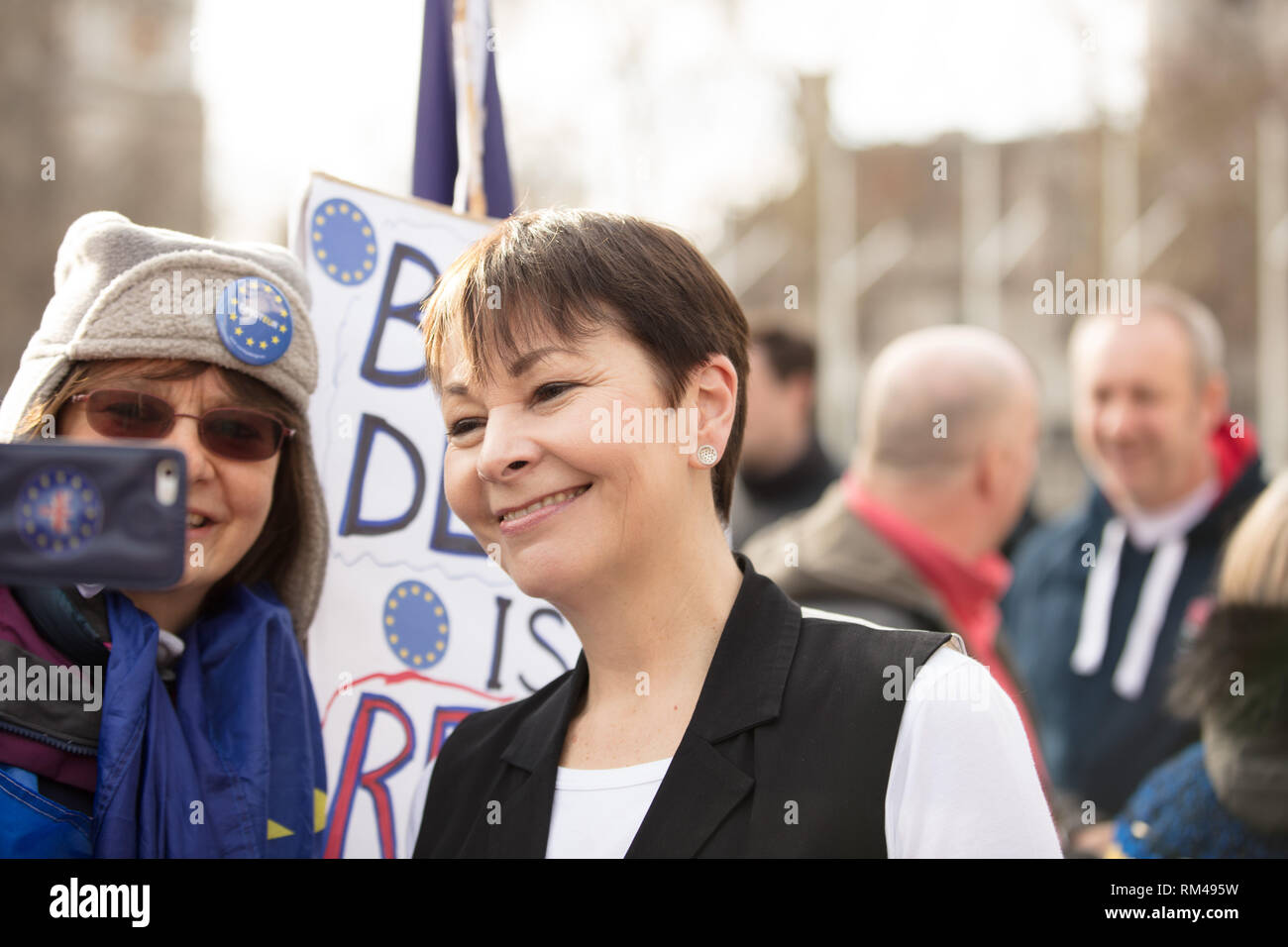 London, UK. 13th February 2019. Remainer takes a picture with her mobile phone together with Caroline Green, MP, on Parliament Square, London UK, today. Credit: Joe Kuis /Alamy Live News Stock Photo