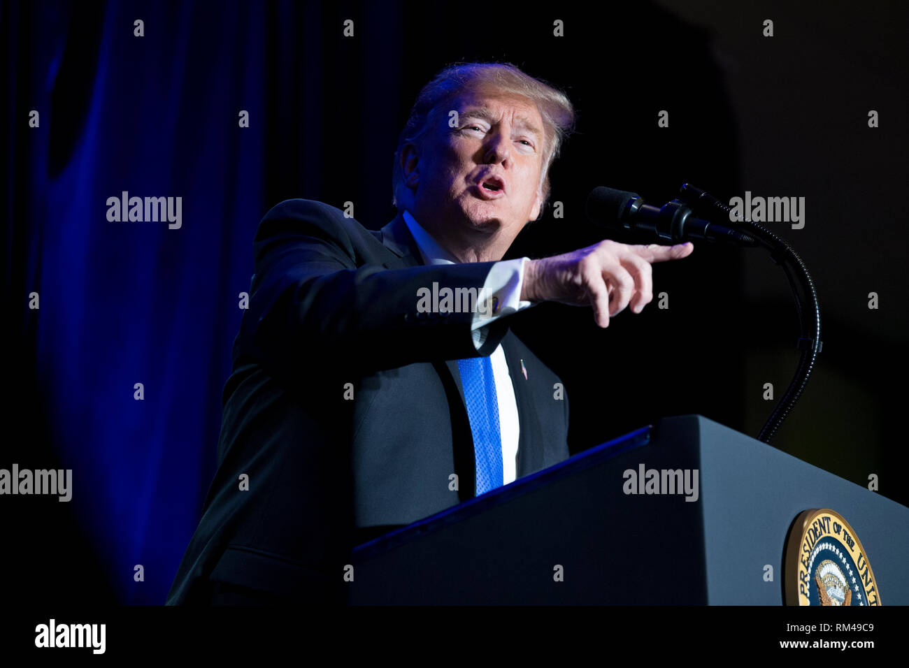 US President Donald J. Trump gestures while delivering remarks at the Major County Sheriffs and Major Cities Chiefs Association Joint Conference, in Washington, DC, USA, 13 February 2019. Trump took the opportunity to deliver remarks on his border-security and immigration policy. Republican leaders are asking Trump to sign legislation that allocates about 1.375 billion USD (1.218 billion euros) for over fifty miles of physical barriers along the border. Signing the agreement would prevent another partial shutdown of the federal government that would begin 16 February. Credit: Michael Reynolds Stock Photo