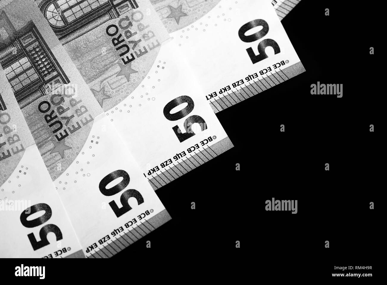 fifty-euro-banknotes-on-a-dark-background-close-up-black-and-white