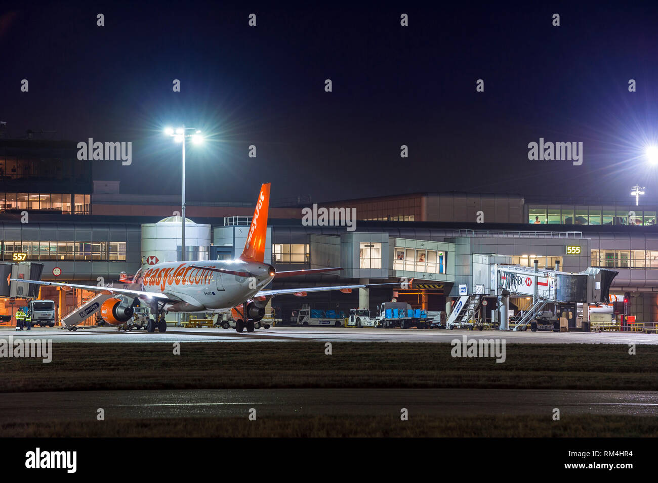 Easyjet aeroplane waiting on the apron at Gatwick Airport in the UK, at dusk. Stock Photo