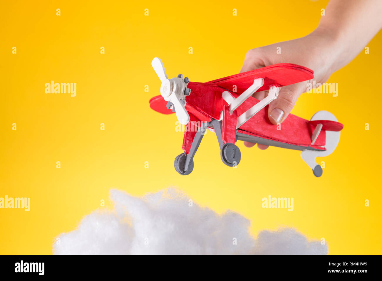 child plays with wooden toy plane Stock Photo