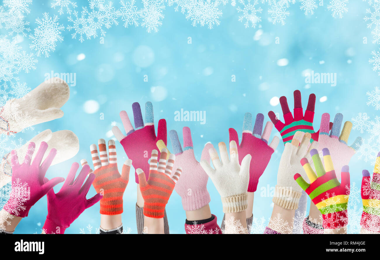 children gloves and winter snow background with snowflakes Stock Photo