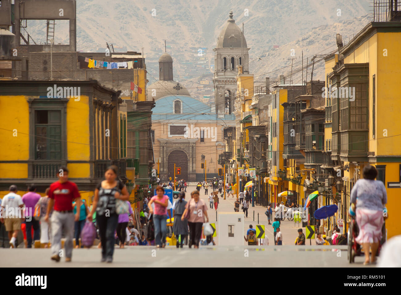 Children returning from school walking towards traditional balconies in Lima,Peru Stock Photo