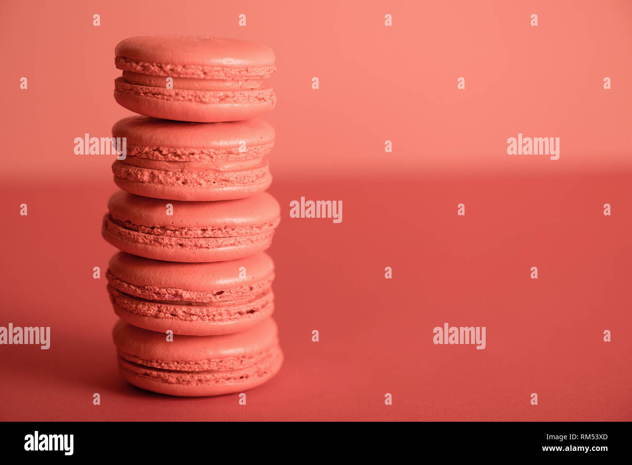 sweet macaroons in Living coral color with copy space. Pantone color of the year 2019 concept Stock Photo