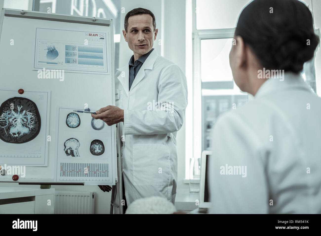 Professional male medical specialist pointing on MRI photo Stock Photo