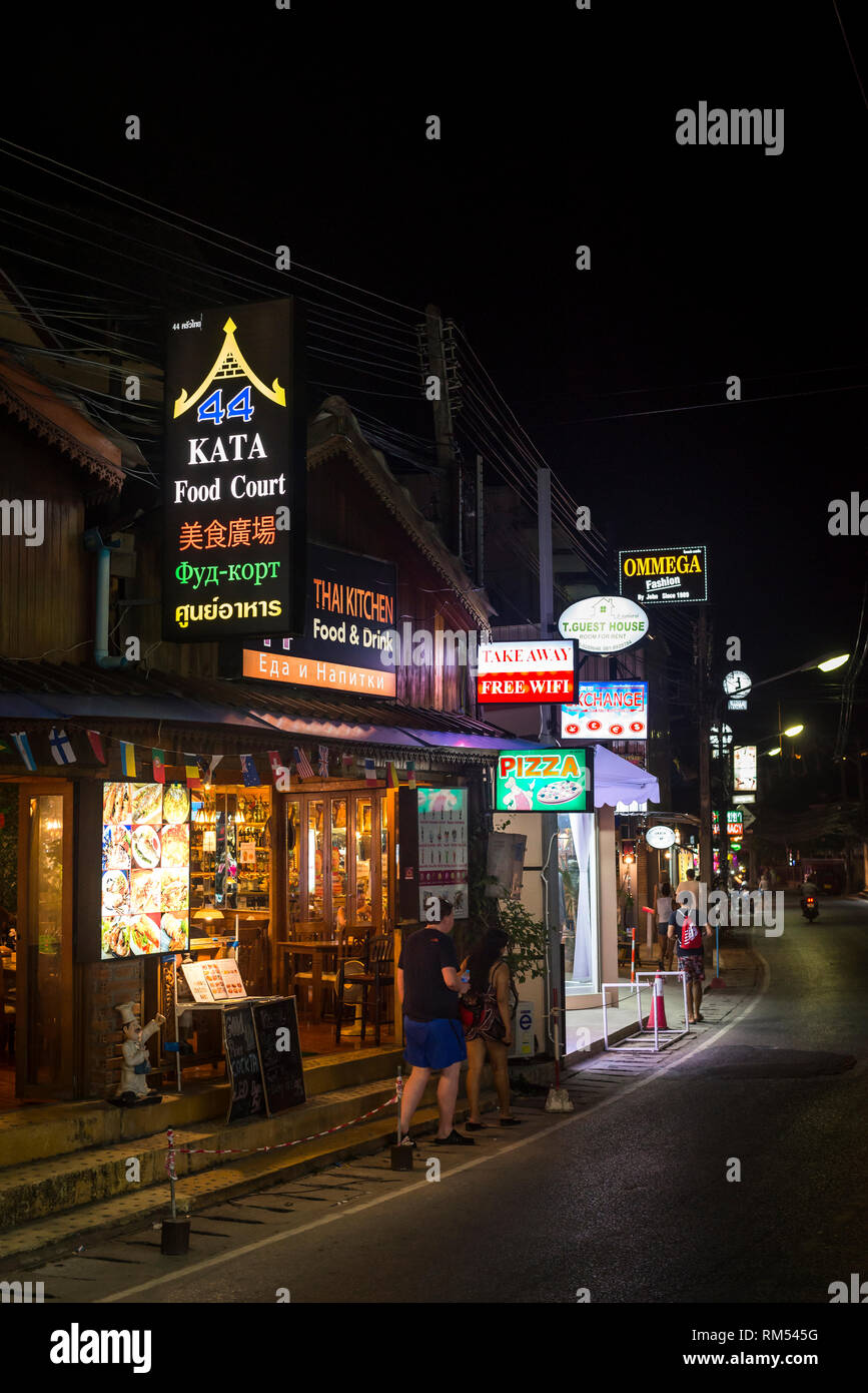 Neon shop signs on a street in Phuket, Thailand at night. Stock Photo