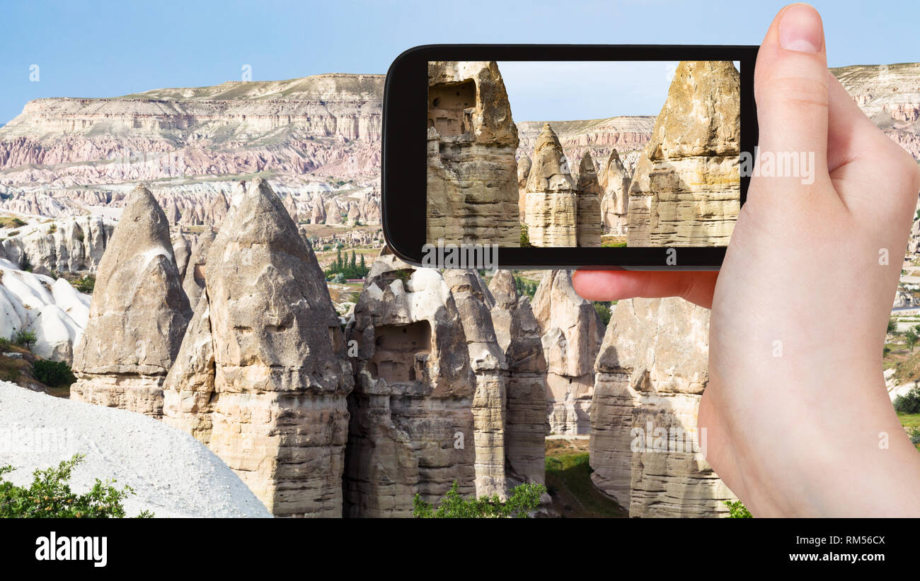 travel concept - tourist photographs of old fairy chimney rocks in ...