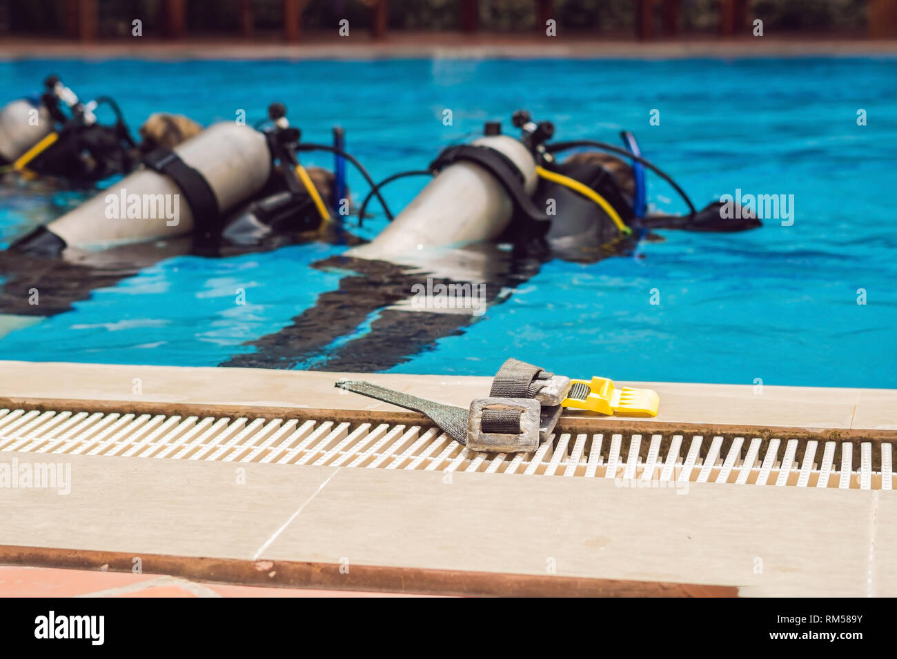 Diving instructor and students. Instructor teaches students to dive