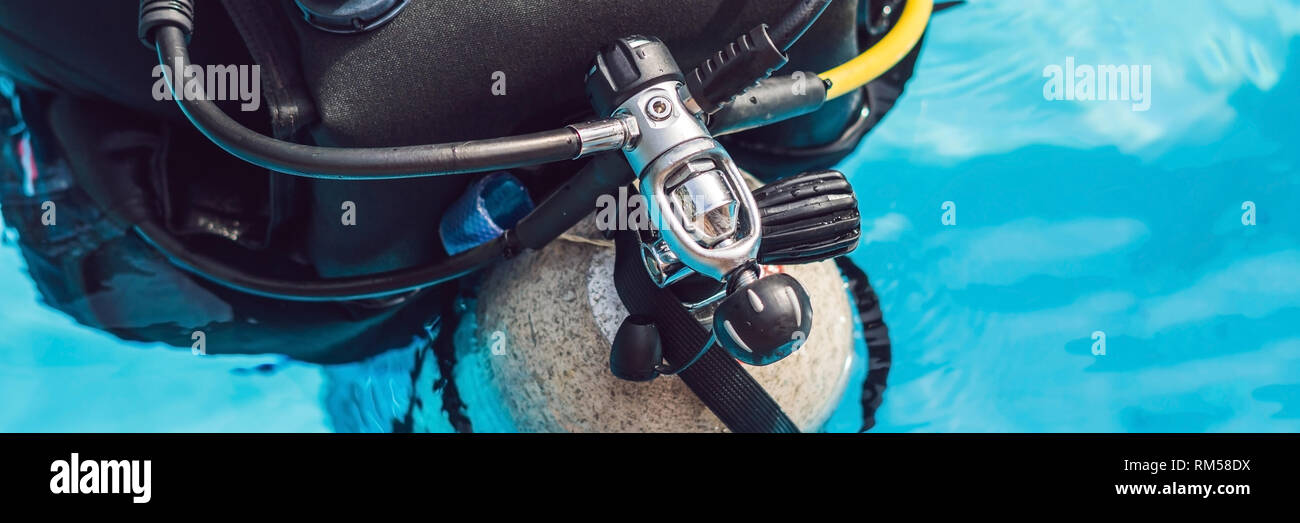 grey scuba diving air oxygen tank on the back of a scuba diver BANNER