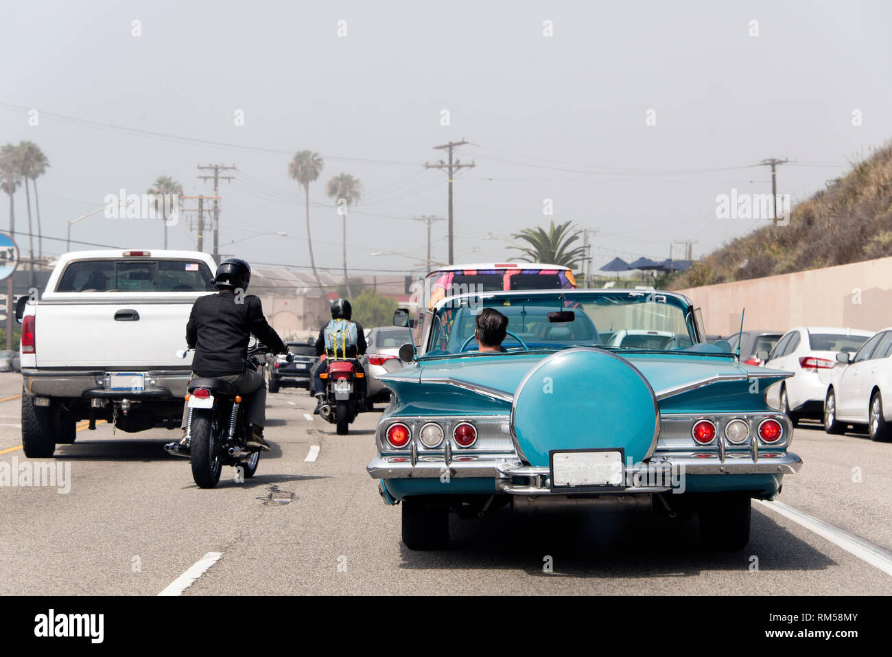 A traffic jam in Malibu, California with a vintage convertible car