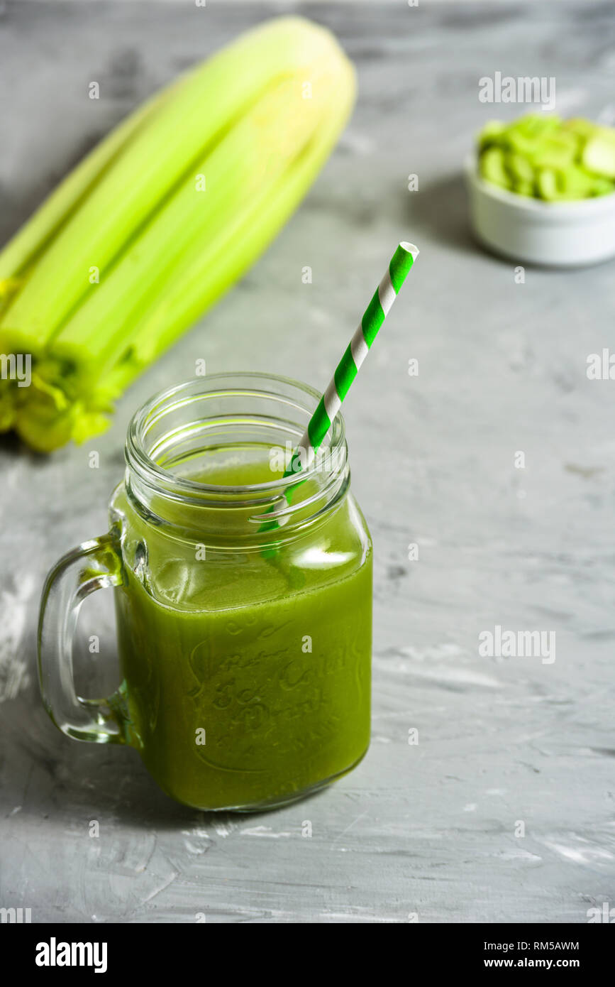 Celery Healthy Green Juice in jar on grey background Stock Photo