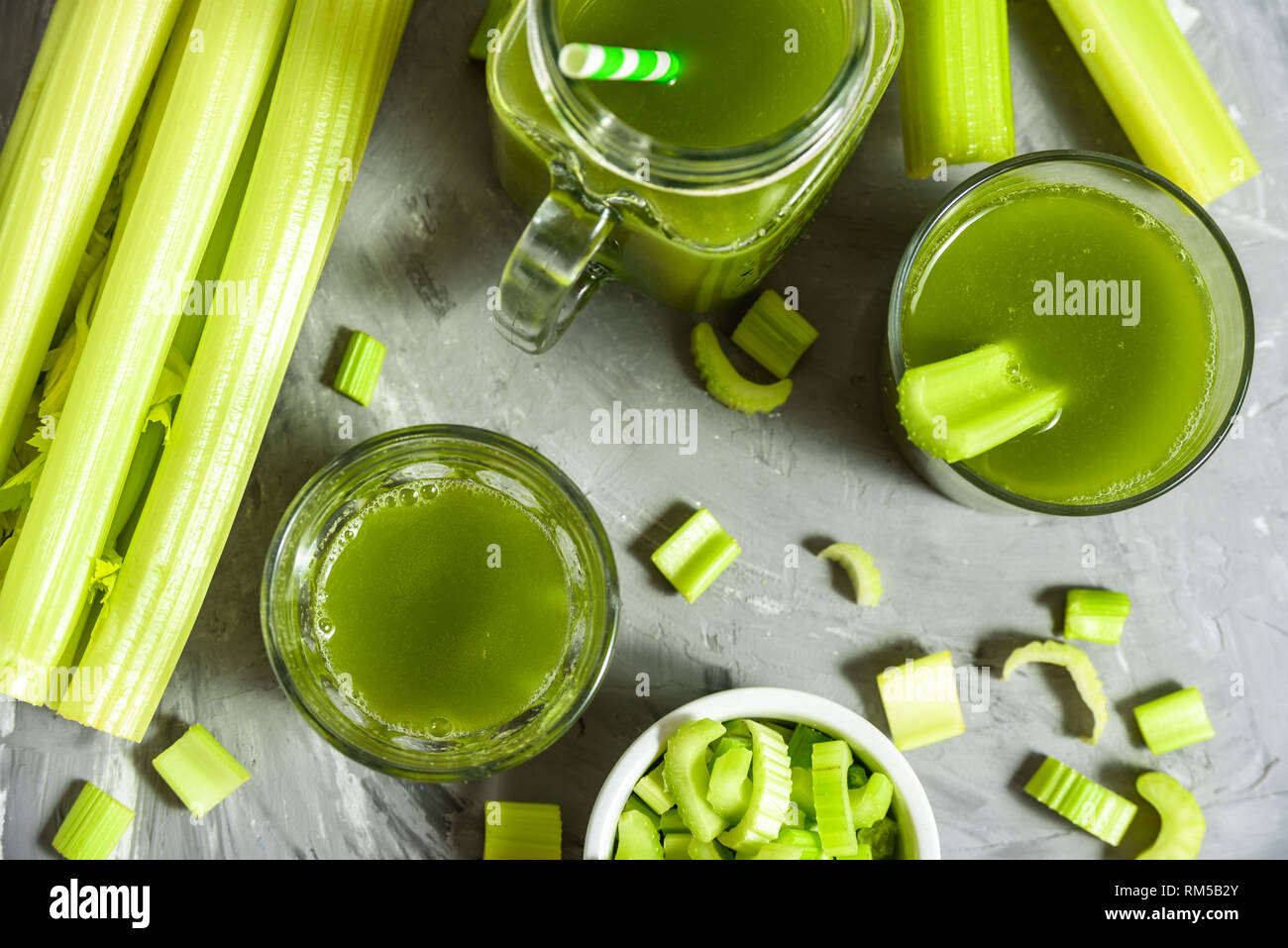 Celery Healthy Green Juice glasses top view on grey background Stock Photo