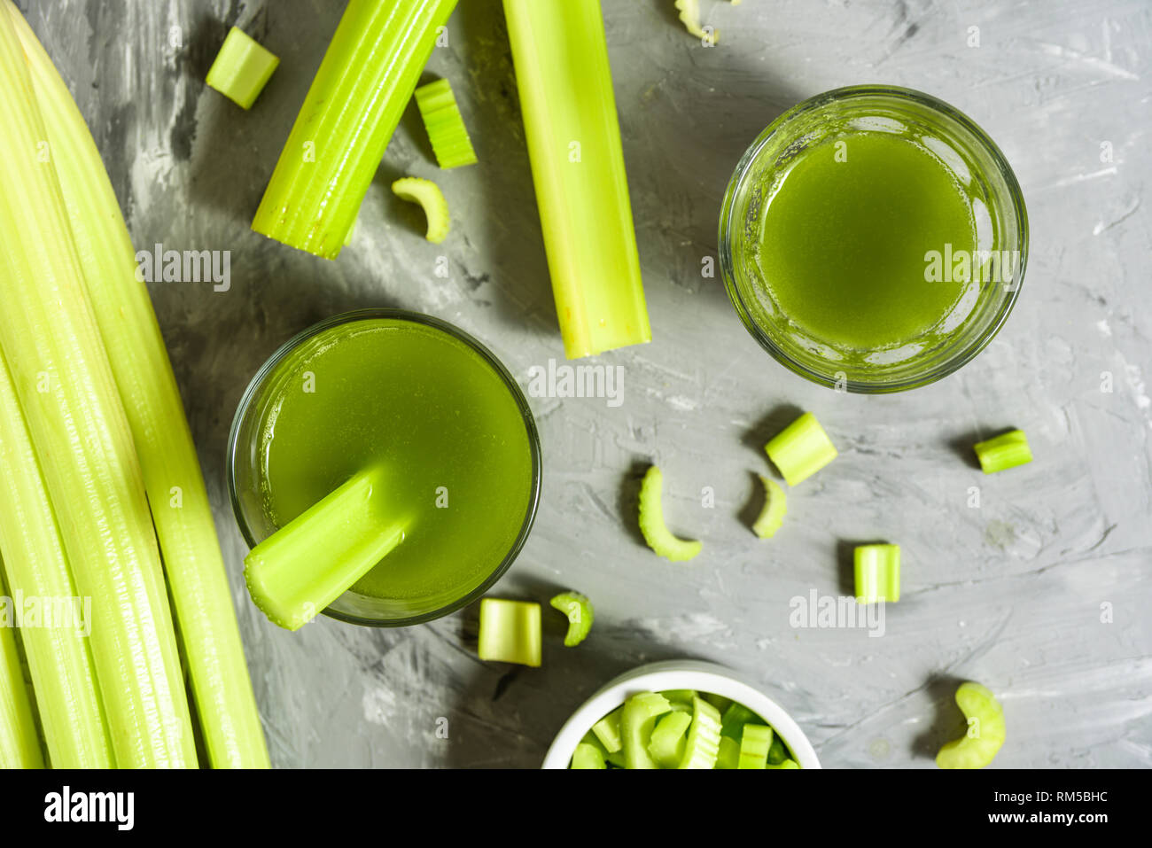 Celery Healthy Green Juice glasses top view on grey background Stock Photo