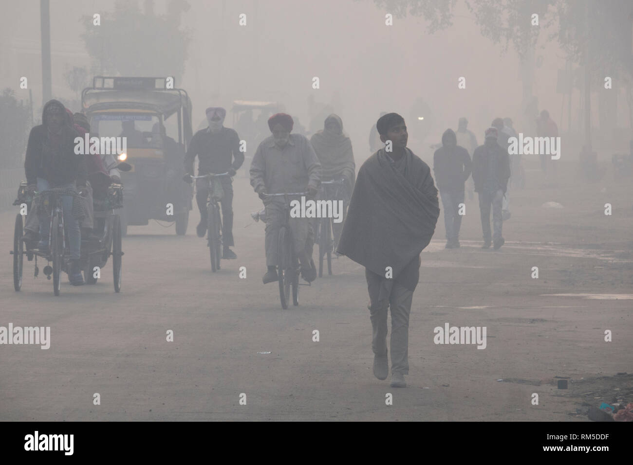 Early morning commuters in hazardous levels of air pollution in Amritsar, India Stock Photo