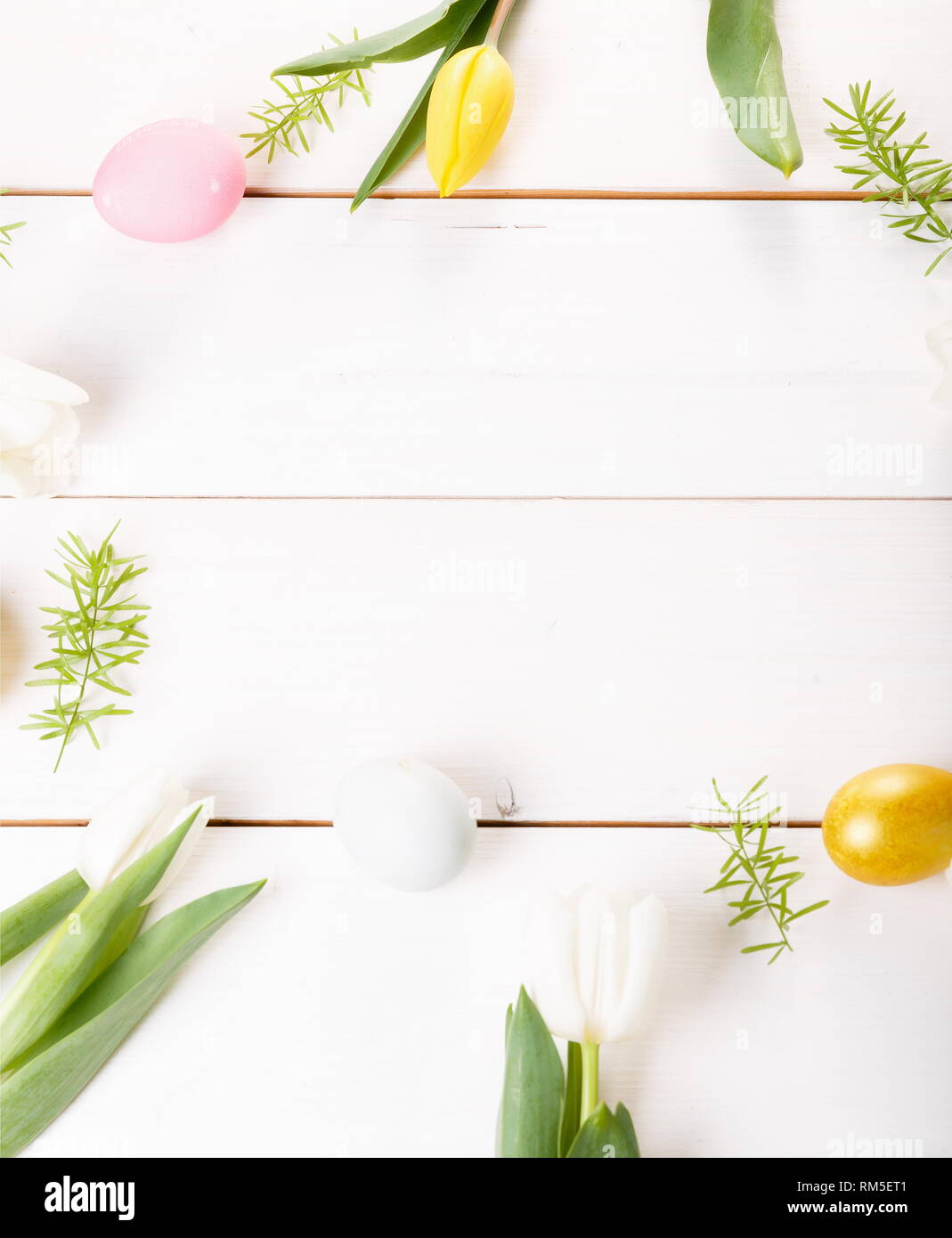 Easter background with Easter eggs and spring flowers. Top view with ...