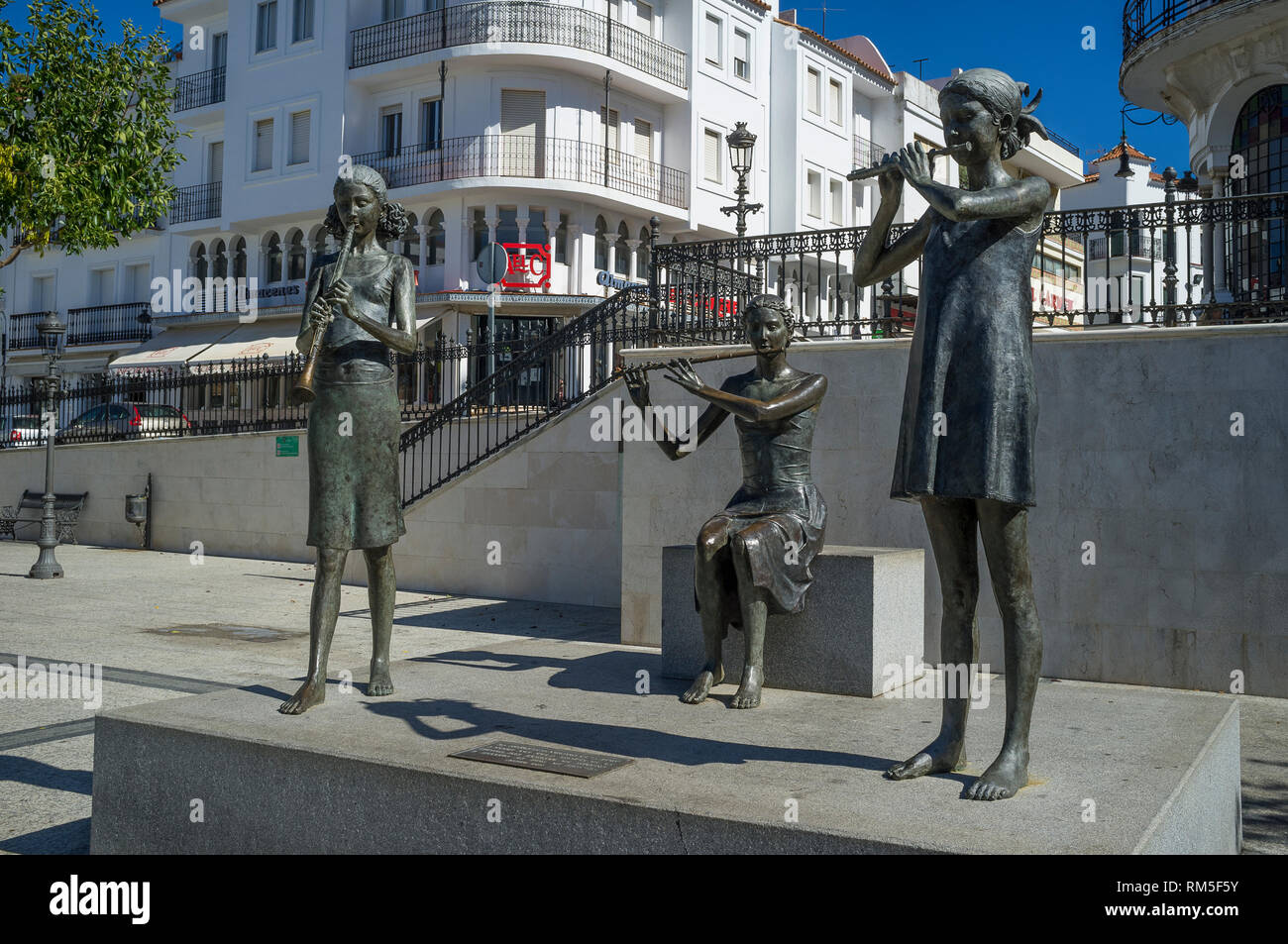 Bronze sculptures of young girls playing musical instruments in Plaza de Marques de Aracena, Aracena, Andalucia, Spain Stock Photo