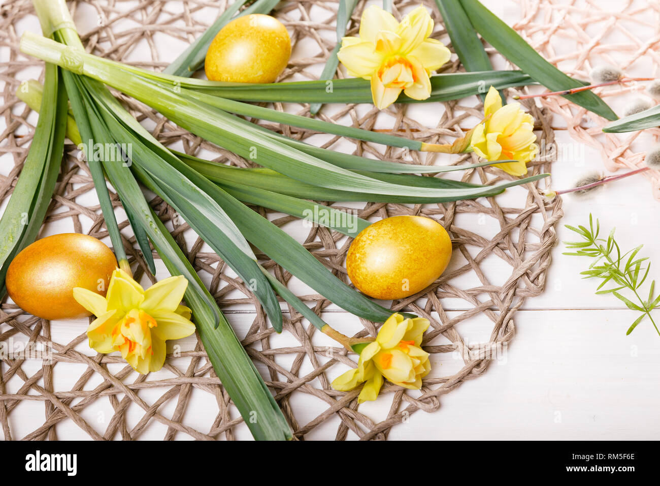 Easter background with Easter eggs and spring flowers. Top view with ...