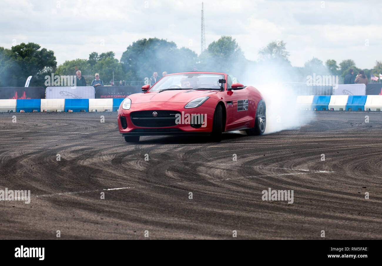 Drifting demonstration performed in a Jaguar F-Type S in the adrenaline zone of the Silverstone Classic 2017 Stock Photo