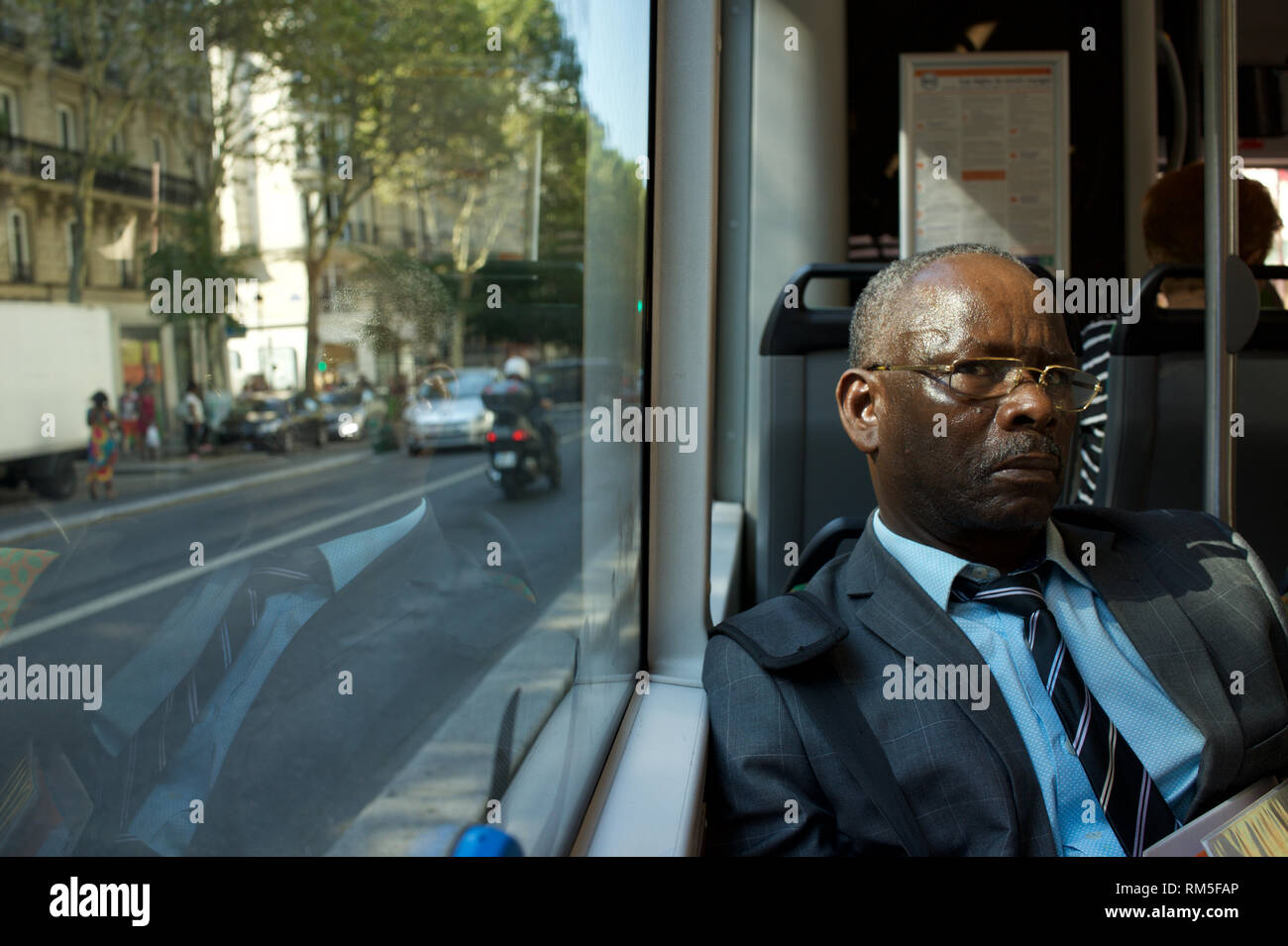 Businessman travelling by bus, Boulevard Barbès, 75018 Paris Stock Photo