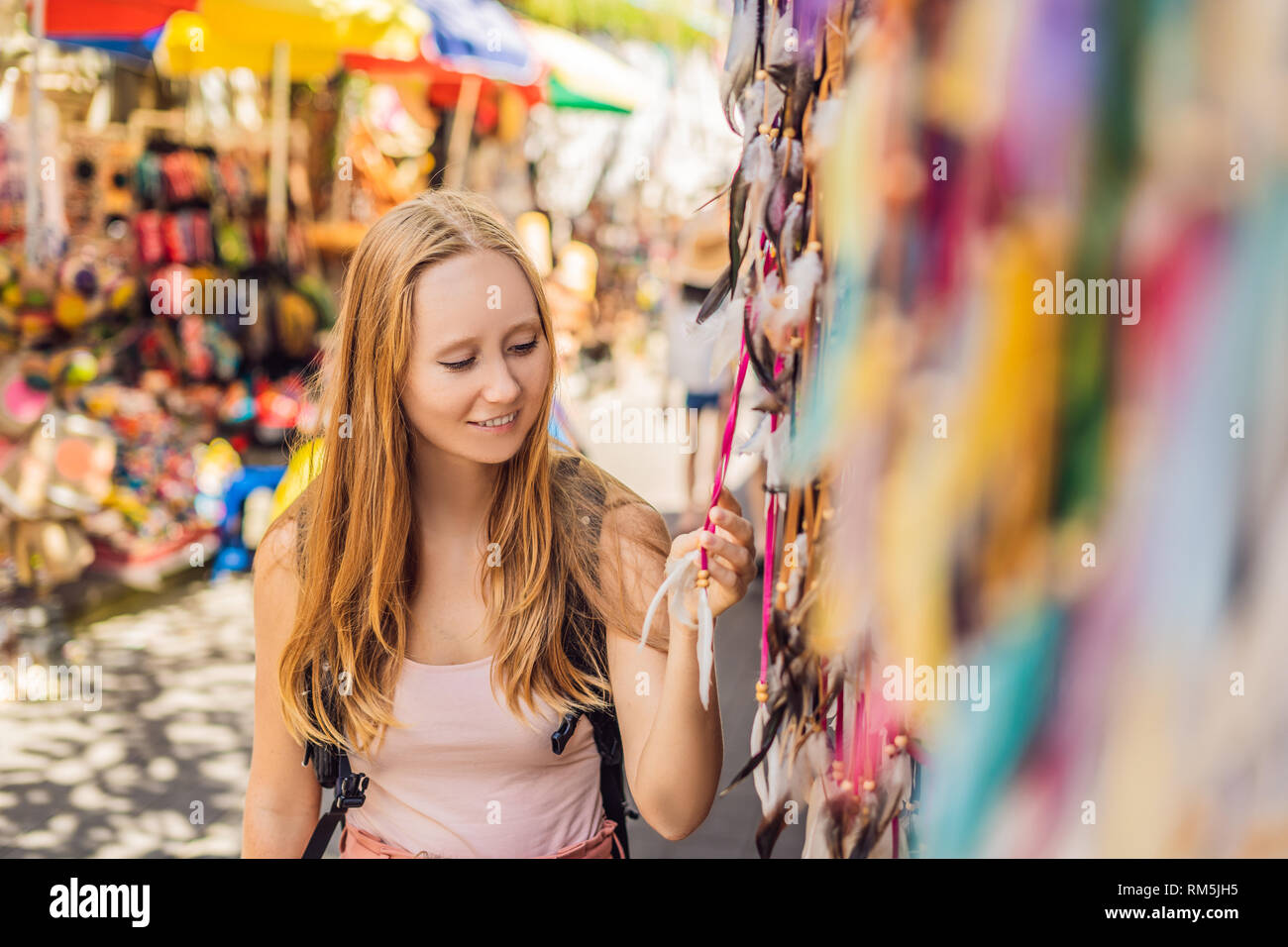 Woman traveler choose souvenirs in the market at Ubud in Bali, Indonesia Stock Photo