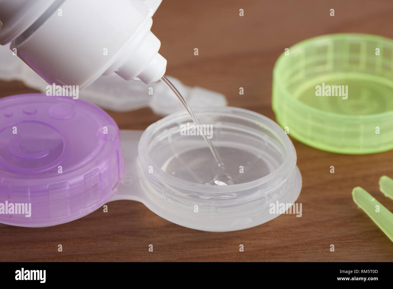 Filling lens case with contact lens solution Stock Photo