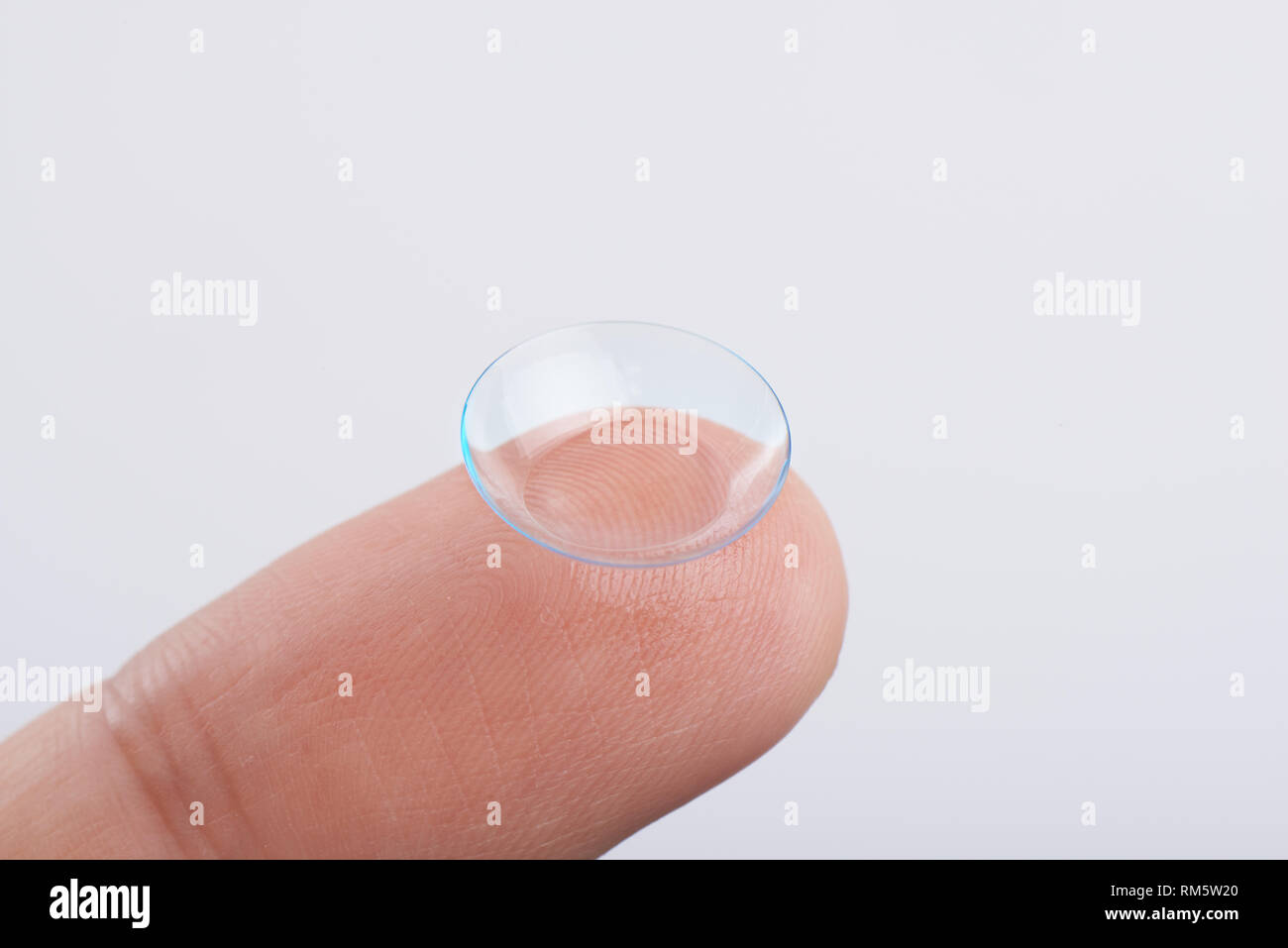 silicon hydrogel contact lens on finger top on white background Stock Photo