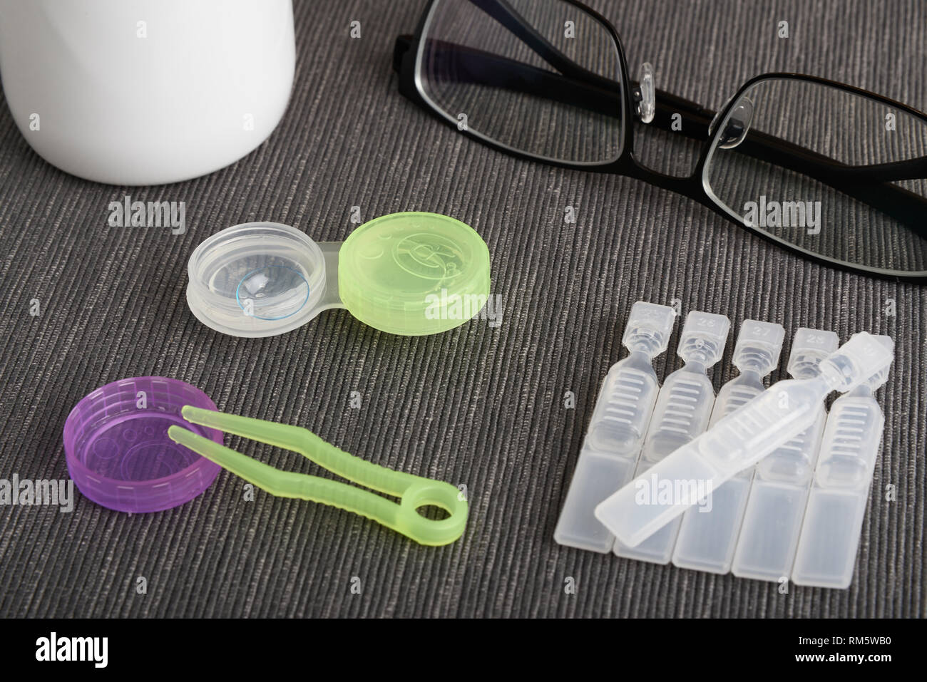 Contact lenses and artificial tear eye drops with tweezers, case and multipurpose solution Stock