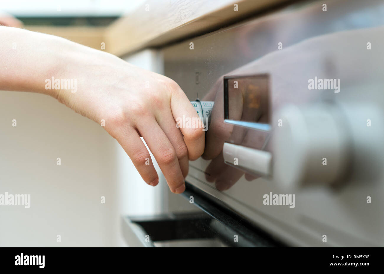 Dangerous situation in the kitchen. Child playing with electric oven