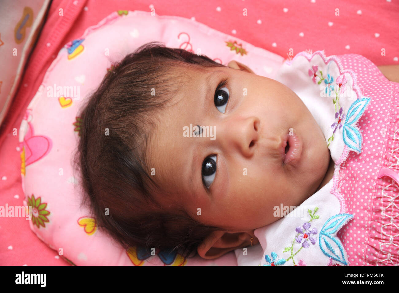 cute baby girl lying in crib Stock Photo