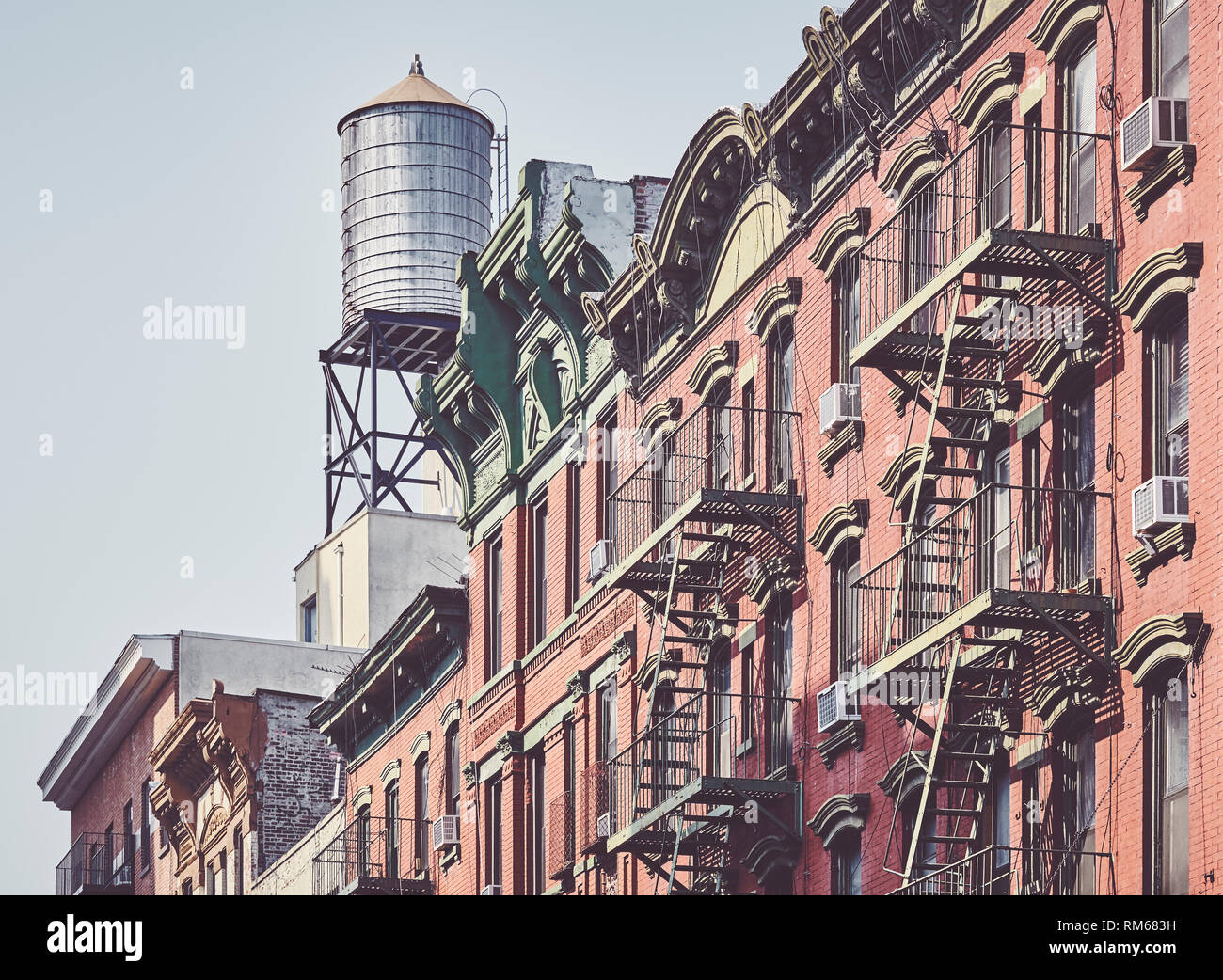 Water tank and fire escapes, symbols of New York City, color toning applied, USA. Stock Photo