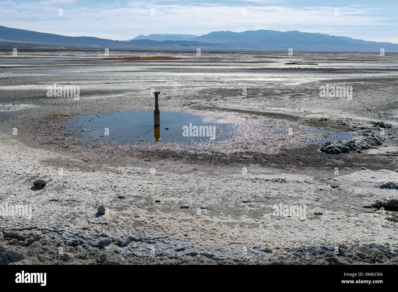 Sprinkler pipe and puddle in Owens Lake near Keeler, California, USA Stock Photo