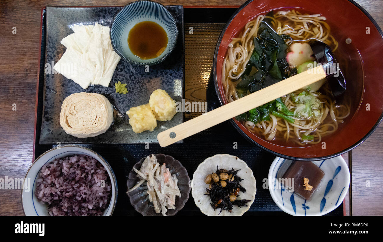 Udon wheat noodles with hot soup, roll soy milk skin, and tempura Stock