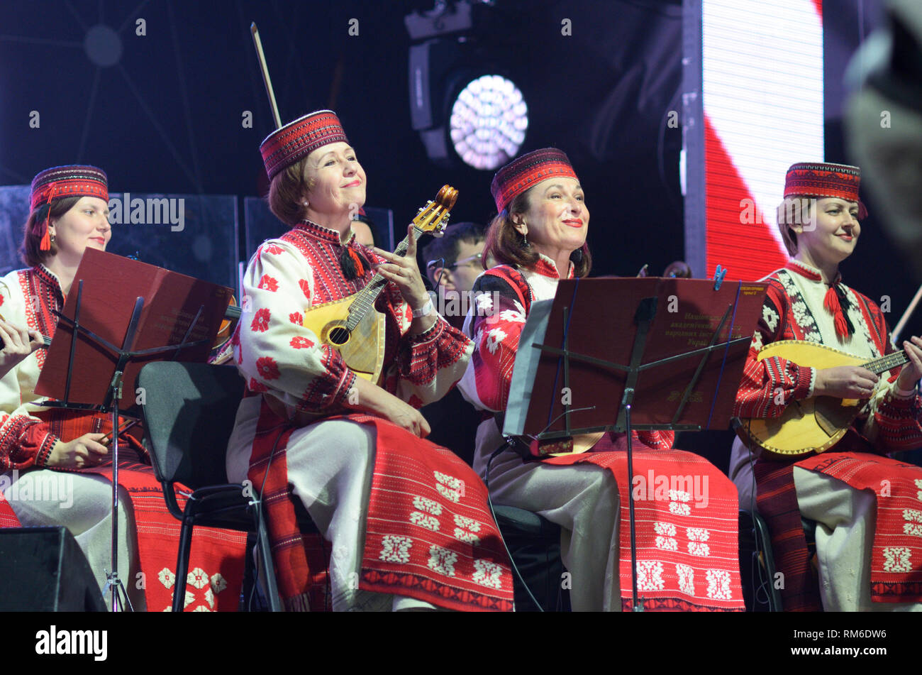 Ethno orchestra performing, women in a Ukrainian native dress playing string instruments. April 26, 2018.Kiev,Ukraine Stock Photo