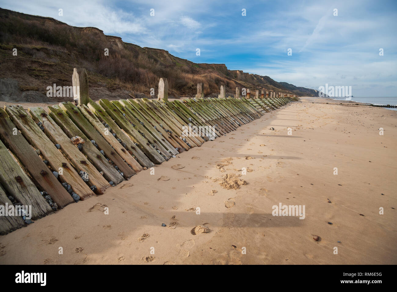 wooden beach groynes, coastal sea defences at overstrand on the norfolk