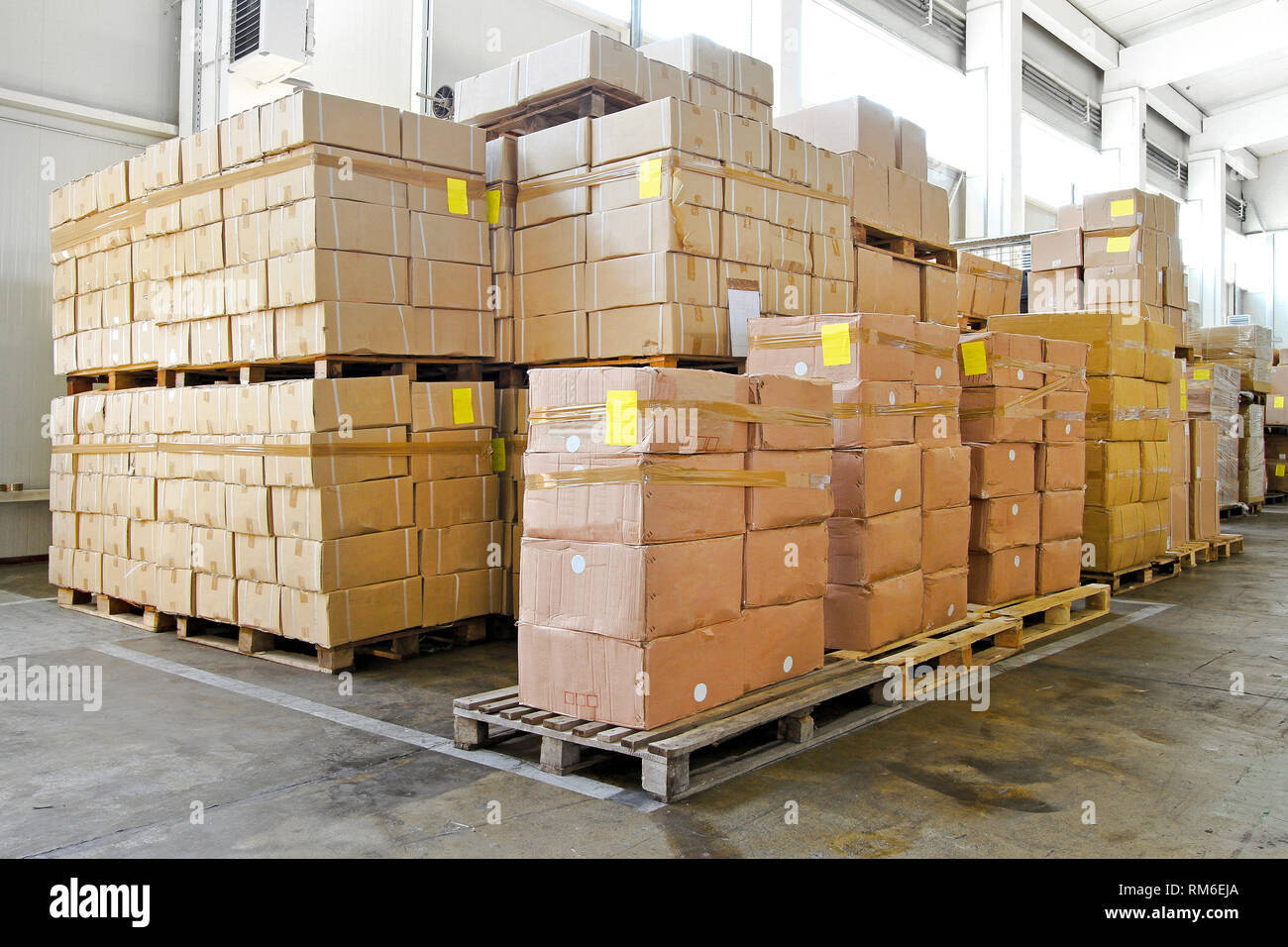 Big pile of boxes in distribution warehouse Stock Photo - Alamy