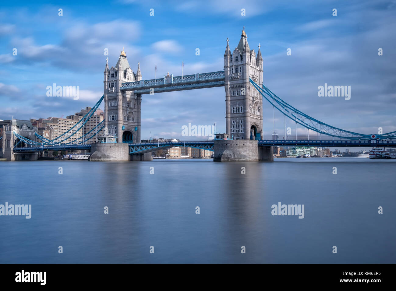 A twenty second exposure, taken of Tower Bridge, England, to smooth out the water of the English River Thames Also, to make the traffic less visible. Stock Photo