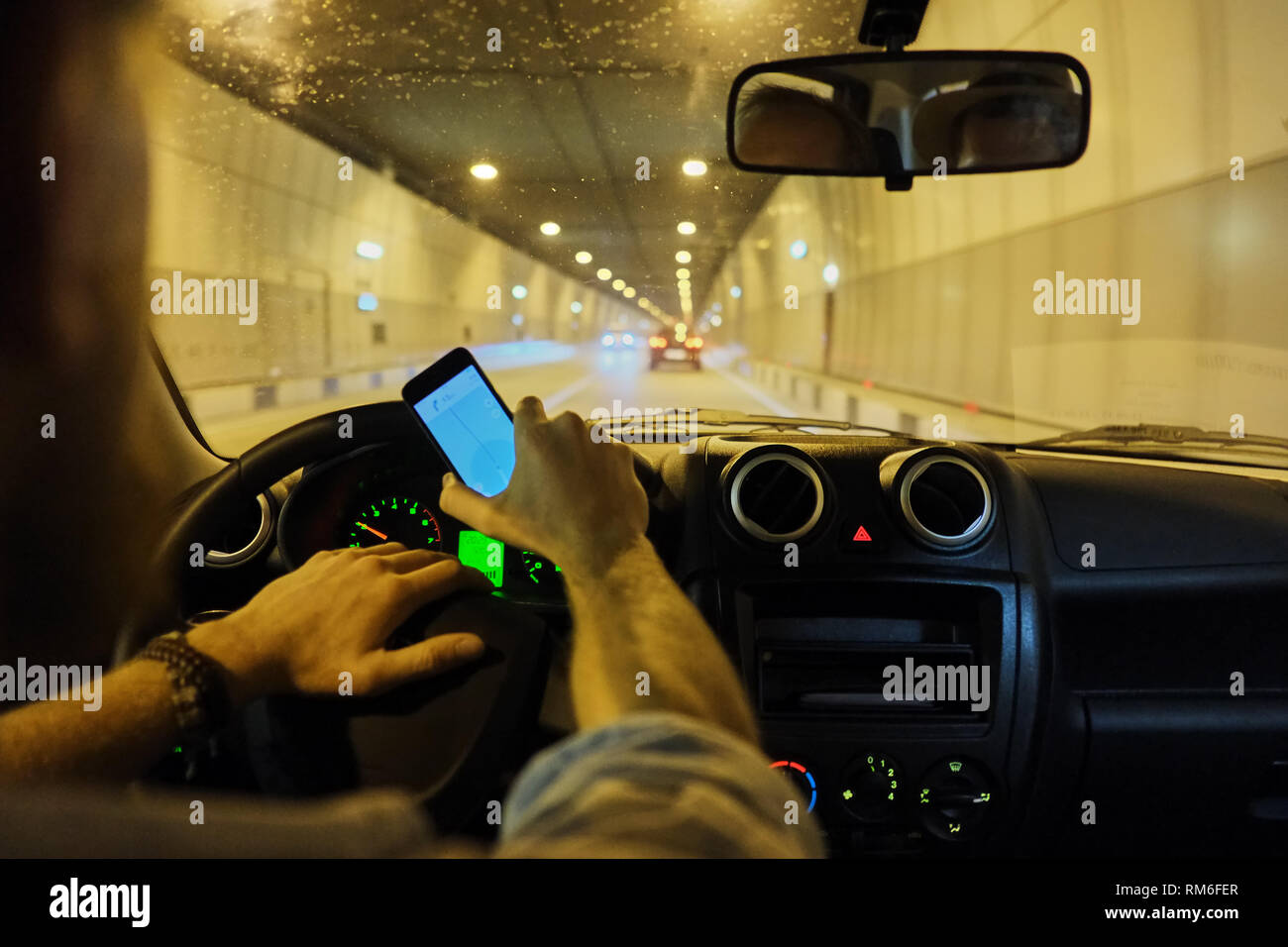 transportation and vehicle concept - man using laptop computer in car ...