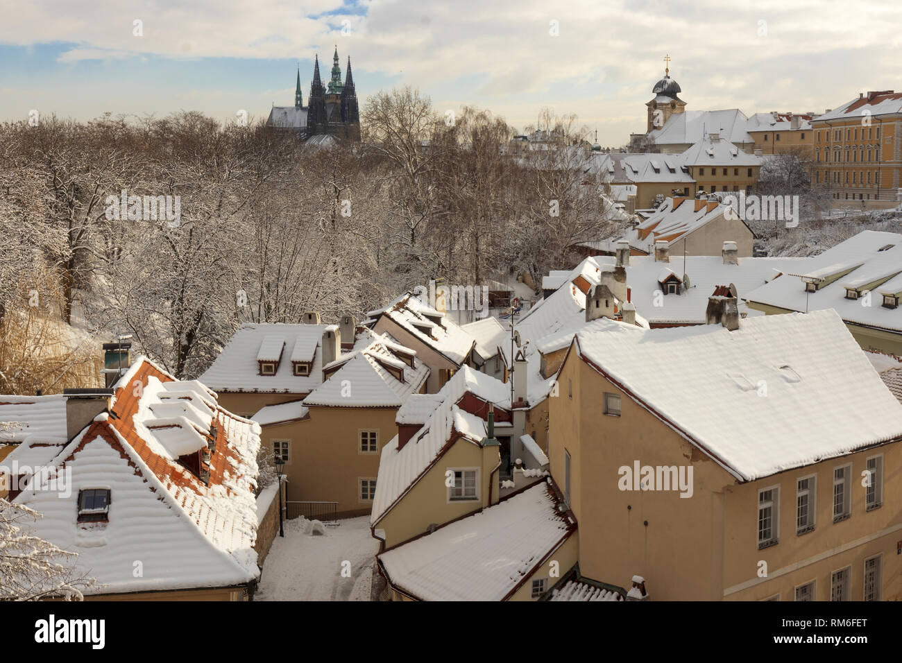 Snowy roofs and streets of New World, district of Prague-Hradcany, in the close neighborhood of Prague Castle. Sunny day in winter season. One of the  Stock Photo