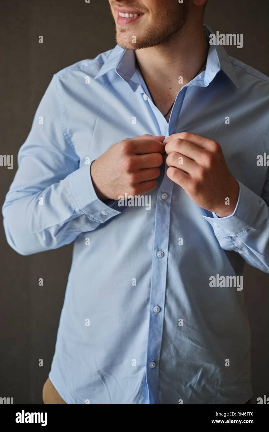 Man adjusting his shirt buttons Stock Photo Alamy