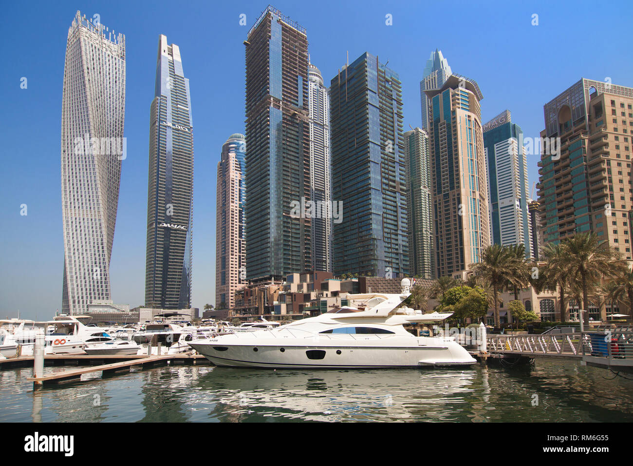 Dubai, United Arab Emirates - September 8, 2018: Yachts and buildings of Dubai Marina seen from the Dubai Marina Walk, Dubai, United Arab Emirates. Stock Photo