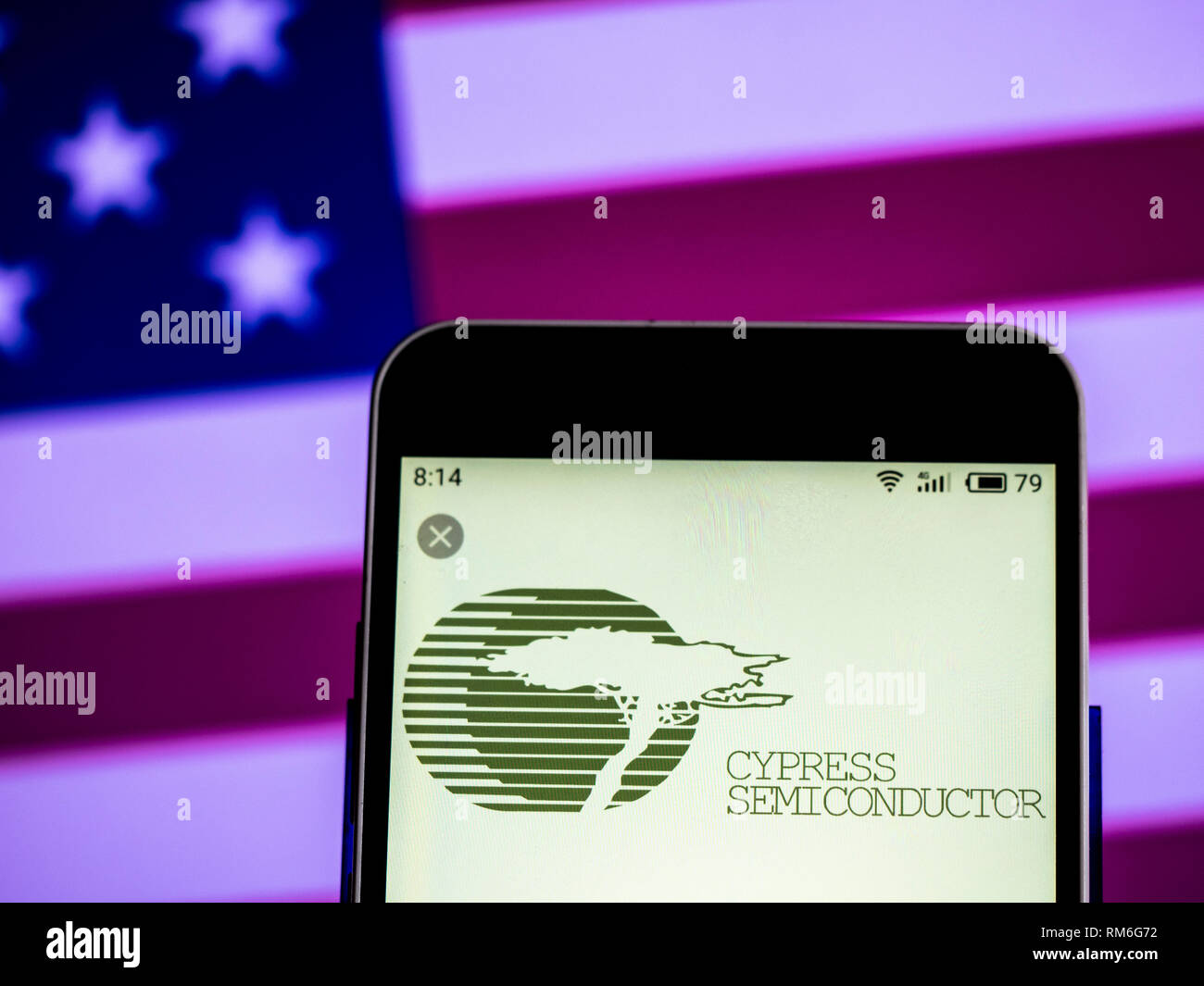 Cypress Semiconductor company logo seen displayed on smart phone Stock