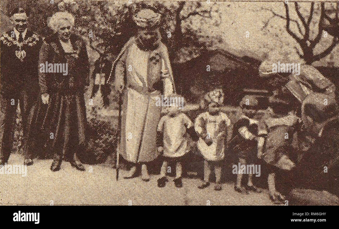 Circa 1939, A press photo depicting Queen Mary of Britain (Mary of Teck) -1867-1953 -visiting a children's hospital accompanied by a local mayor & mayoress wearing their chains of office. She was Empress of India and the wife of King George V. In her lifetime she was also Duchess of York, Duchess of Cornwall, and Princess of Wales Stock Photo