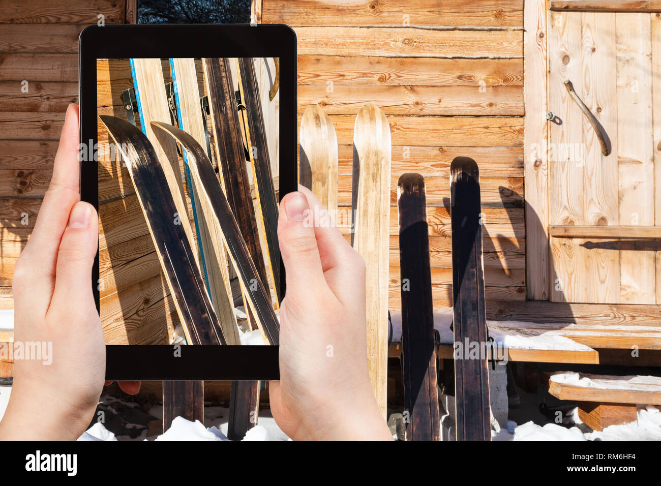 travel concept tourist photographs of wide hunting skis near wall of