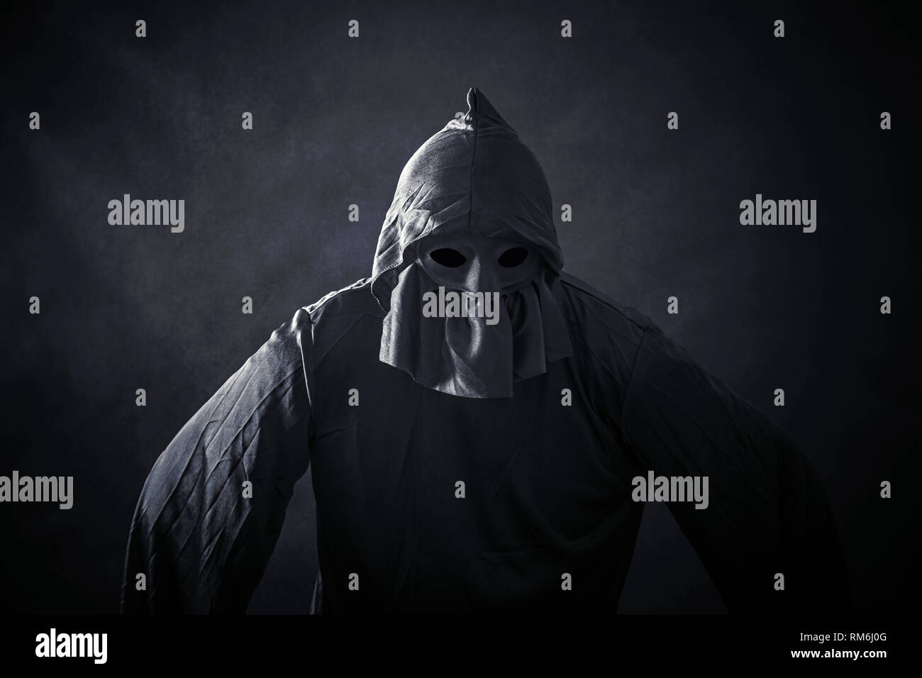 Scary figure in hooded cloak Stock Photo - Alamy
